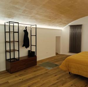 a bedroom with a bed and a dresser in a room at Alma Mater Suite in Matera