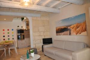 - un salon avec un canapé et une table dans l'établissement Holiday in Arles -Maison du Centre Historique, à Arles