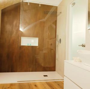 a bathroom with a shower and a sink at Alma Mater Suite in Matera