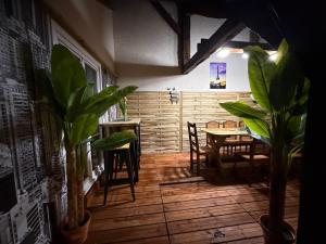 a dining room with a table and chairs and plants at Logement climatisé avec cuisine équipée in Amboise +26 photos