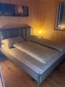 a bed in a room with two mattressesurrency sidx sidx sidx sidx at Ferienwohnung MARTIN in Göfis