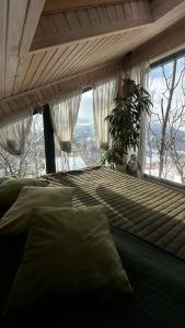 a bedroom with a bed and a window with a view at Apart Garden з чаном-джакузі in Slavske