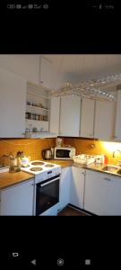 a kitchen with white cabinets and a stove top oven at Karlskrona centrum in Karlskrona +6 photos