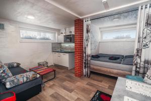 a living room with a couch and a bed at Penzion U Hada in Velké Pavlovice