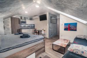 a small bedroom with a bed and a couch at Penzion U Hada in Velké Pavlovice