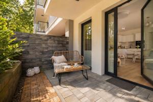 a patio with a chair and a table at Baltic Harmony - Easy-Rent Apartments in Pobierowo
