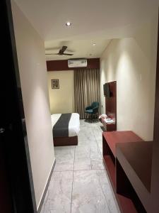 a hotel room with a bed and a desk at Hotel Maharaja 2 in Udaipur