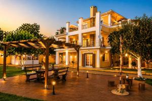 a house with a picnic table in front of it at Acqui Apartments in Argostoli