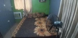 a bedroom with a bed with a fan on it at JK Hotels in Lagos