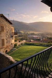 a view from the balcony of a building with a green field at Garden House - InBorgo in Acquasparta