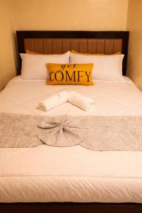 a white bed with a bow tie on it at H&Dluxe in Murangʼa +11 photos