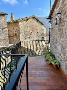 a balcony with a black railing next to a building at Garden House - InBorgo in Acquasparta +3 photos