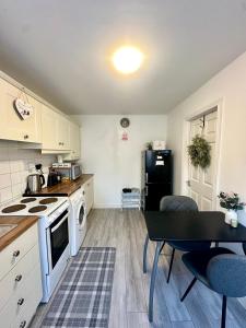a kitchen with a table and a stove and a refrigerator at Little Gem in Dublin +13 photos