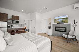 a white bedroom with a bed and a fireplace at 18112-2 Forestbrook Loop in Bend +17 photos