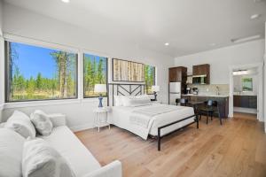 a white bedroom with a bed and a couch at 18112-2 Forestbrook Loop in Bend