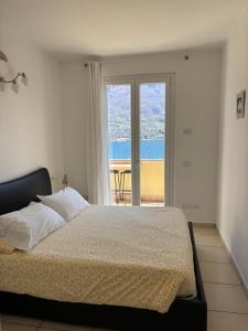 a bedroom with a bed with a view of the ocean at Villa Oliveto Apartments in Oliveto Lario