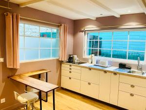 a kitchen with a sink and a window at Maisonnette Cosy Villa Ajna in Bayonne