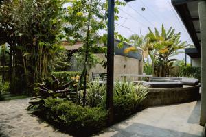 a garden with a bench and some plants at Migano Hotel in Ruhengeri