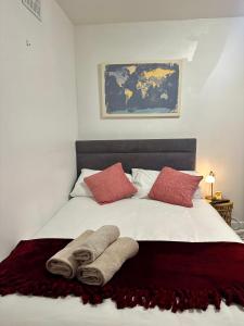 a bedroom with a bed with two towels on it at Little Gem in Dublin