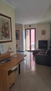 a living room with a couch and a table at The Happy Goat Apartment in Germignaga
