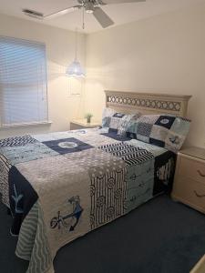 a bedroom with a bed with a quilt on it at Vermont By The Sea in Cape May