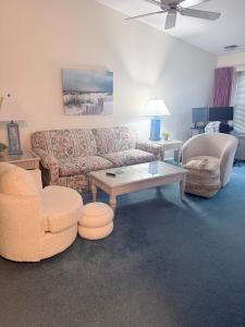 a living room with a couch and two chairs and a table at Vermont By The Sea in Cape May