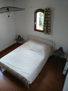 a white bed in a room with a window at le bien l'authie in Colline-Beaumont