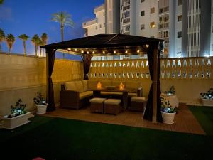 a gazebo with a table and chairs on a patio at EL DESCANSO in Calpe