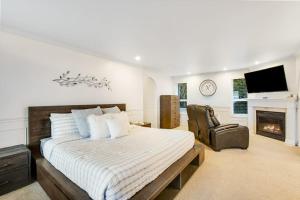 a bedroom with a large bed and a fireplace at Island Time Escape in Saratoga Shores