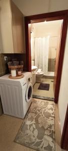 a bathroom with a washing machine and a toilet at Zagrljaj prirode in Blagaj +28 photos