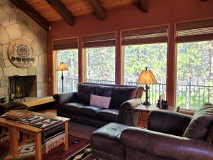 a living room with leather furniture and a fireplace at 6 Colonial Lane in Sunriver