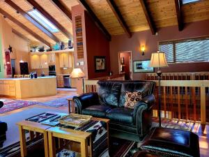a living room with a leather chair and a table at 6 Colonial Lane in Sunriver