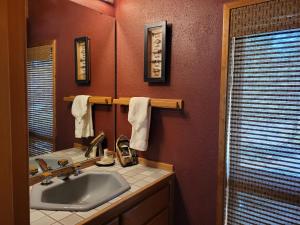 a bathroom with a sink and a mirror at 6 Colonial Lane in Sunriver