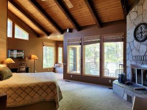 a bedroom with a large bed and a fireplace at 6 Colonial Lane in Sunriver +36 photos