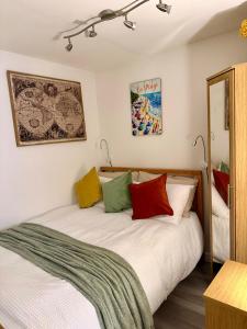 a bedroom with two beds with colorful pillows at St Catherines, Winterborne Lodge in Blandford Forum