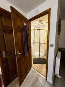 an open door to a room with a glass door at St Catherines, Winterborne Lodge in Blandford Forum +57 photos