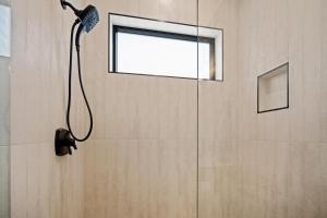 a shower in a bathroom with a window at 18124-2 Forestbrook Loop in Bend +18 photos
