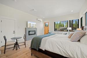 a bedroom with a large bed and a table and chairs at 18124-2 Forestbrook Loop in Bend