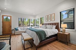 a bedroom with a large bed and a couch at 18124-2 Forestbrook Loop in Bend