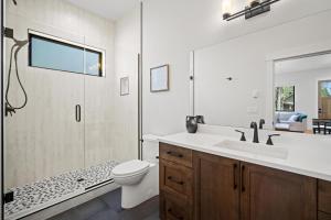a bathroom with a shower and a toilet and a sink at 18124-2 Forestbrook Loop in Bend