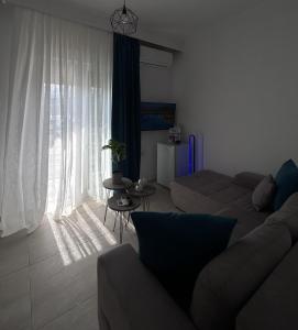 a living room with a couch and a table at Ammos in Kavála