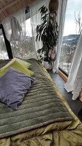 a bed sitting in a room with a window at Apart Garden з чаном-джакузі in Slavske +27 photos
