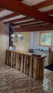 a kitchen with a wooden counter in a room at Cabañas La Piedra del Queso in Melipeuco