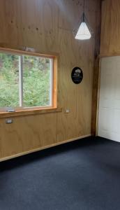 an empty garage with a window and a door at Cabañas La Piedra del Queso in Melipeuco