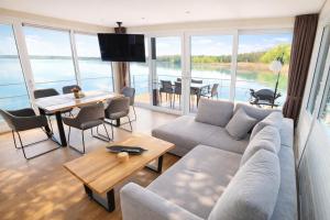 a living room with a couch and a table at Floatinghouse Möwe 2 - LP2 in Vetschau +8 photos