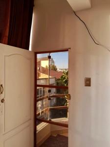 a door leading into a room with a balcony at Hostal Urbano in Tarija