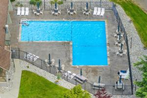 an overhead view of a swimming pool with tables and chairs at Twin Lakes in Rathdrum, ID in Rathdrum
