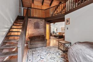 a living room with a couch and a staircase at Twin Lakes in Rathdrum, ID in Rathdrum +24 photos