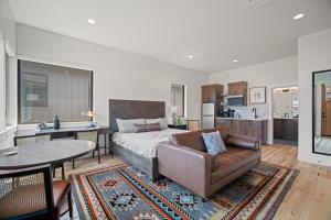 a living room with a bed and a couch and a table at 18129-2 Forestbrook Loop in Bend