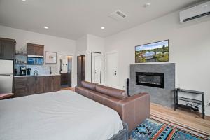 a bedroom with a bed and a couch and a fireplace at 18129-2 Forestbrook Loop in Bend +10 photos